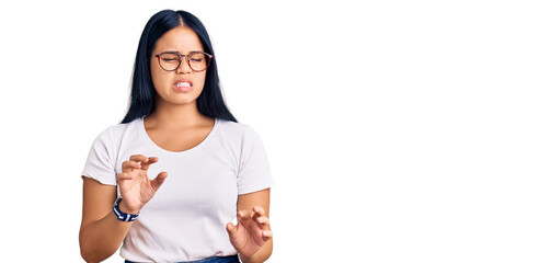 Young beautiful asian girl wearing casual clothes and glasses disgusted expression, displeased and...