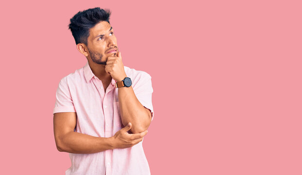 Handsome latin american young man wearing casual summer shirt thinking worried about a question, concerned and nervous with hand on chin