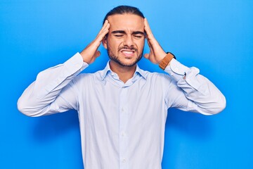 Young handsome man wearing business clothes with hand on head, headache because stress. suffering migraine.
