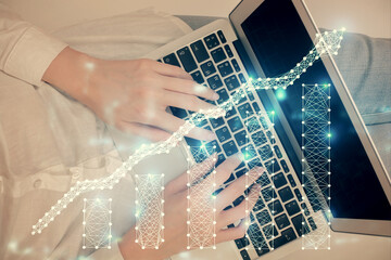 Double exposure of woman hands working on computer and forex chart hologram drawing. Top View....