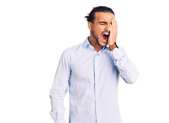 Young handsome man wearing business clothes yawning tired covering half face, eye and mouth with hand. face hurts in pain.