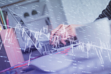 Double exposure of woman hands typing on computer and forex chart hologram drawing. Stock market invest concept.