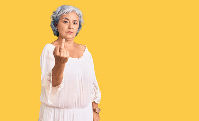 Senior woman with gray hair wearing bohemian style showing middle finger, impolite and rude fuck...