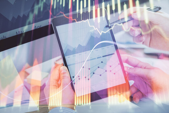 Double exposure of man's hands holding and using a phone and financial chart drawing. Market analysis concept.