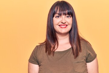 Fototapeta premium Young plus size woman wearing casual clothes with a happy and cool smile on face. lucky person.