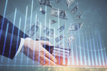 Multi exposure of financial graph drawing hologram and USA dollars bills and man hands. Analysis concept.