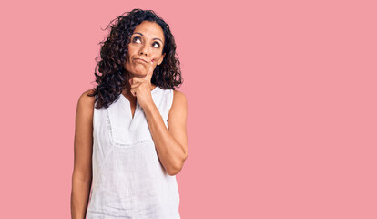 Middle age beautiful woman wearing casual sleeveless t shirt serious face thinking about question...