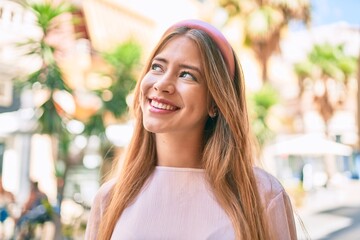 Young caucasian girl smiling happy walking at the city.