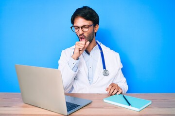 Handsome hispanic man wearing doctor uniform working at the clinic feeling unwell and coughing as symptom for cold or bronchitis. health care concept. - obrazy, fototapety, plakaty