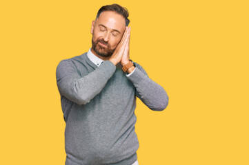 Handsome middle age man wearing business clothes sleeping tired dreaming and posing with hands together while smiling with closed eyes.