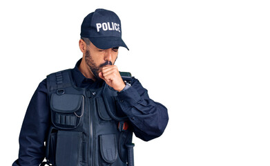 Young hispanic man wearing police uniform feeling unwell and coughing as symptom for cold or...