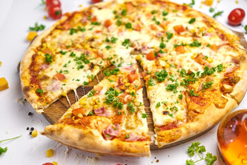 Delicious pizza with sausage, corn, minced meat on wooden plate
