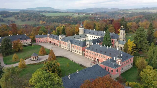 View from drone of impressive medieval Sychrov Castle with large park on sunny autumn day, Liberec Region, Czech Republic