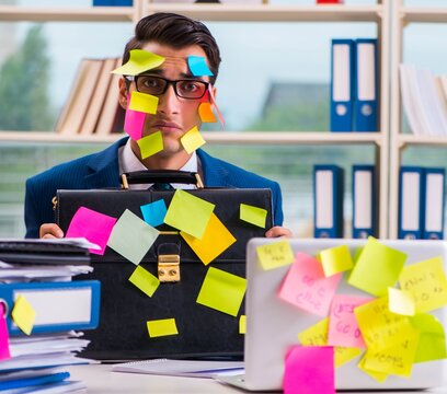 Businessman With Reminder Notes In Multitasking Concept