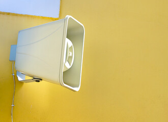 White loudspeaker on a yellow wall
