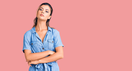 Young beautiful woman wearing casual clothes relaxed with serious expression on face. simple and natural looking at the camera.