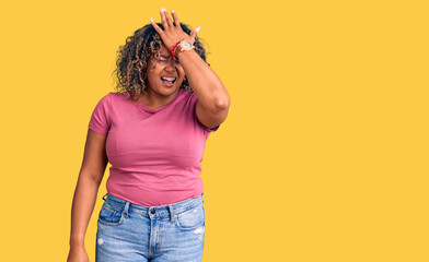 Young african american plus size woman wearing casual clothes surprised with hand on head for mistake, remember error. forgot, bad memory concept.