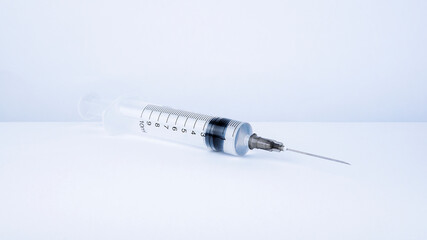 Syringe with liquid vaccine inside, prepare for injection.   