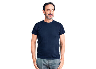 Fototapeta premium Middle age handsome man wearing casual t-shirt smiling looking to the side and staring away thinking.