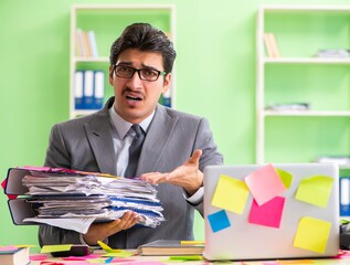 Businessman unhappy with many conflicting priorities sitting in