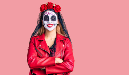 Woman wearing day of the dead costume over background happy face smiling with crossed arms looking at the camera. positive person.