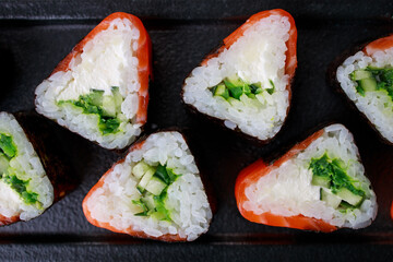 Seafood delicatessen salmon sushi rolls on plate