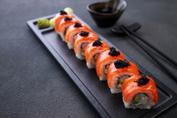 Seafood delicatessen salmon sushi rolls on plate
