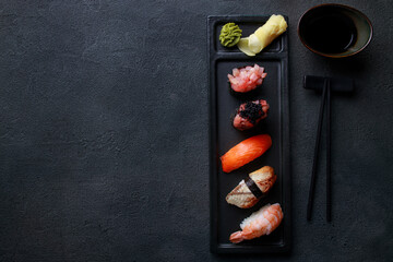 Nigiri sushi set on black plate. Restaurant food