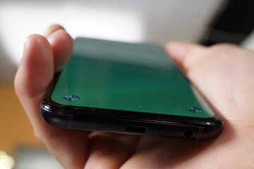 closeup of hand holding mobile phone with greenscreen to be mocap 
