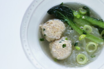 Chinese food, meat ball and glass noodles in green leaves vegetable  soup