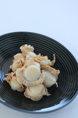 Fototapeta na wymiar Japanese food, boiled scallop on black dish with copy space