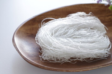 Chinese food ingredient, dried glass noodles on wooden plate