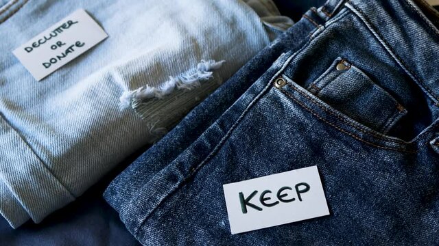 organizing your wardrobe, Keep vs Declutter label on different jeans in various denim colors