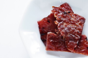 Taiwanese food, spicy beef jerky on dish with copy space