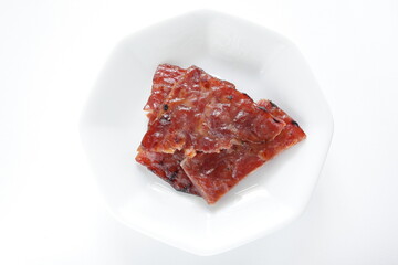 Taiwanese food, spicy beef jerky on dish with copy space