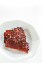 Taiwanese food, spicy beef jerky on dish with copy space