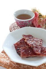 Taiwanese food, spicy beef jerky on dish with copy space