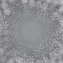 Christmas background of snowflakes of different shape, blur and transparency, arranged in a circle, on gray background