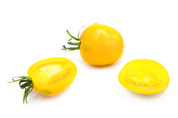 Ripe fresh organic tomato and halves of tomato in dew drops isolated on white background
