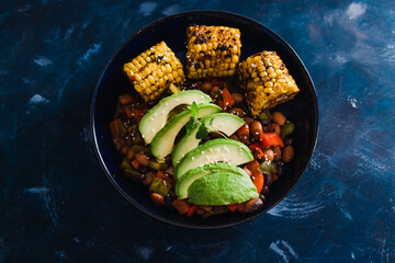 plant-based food,  vegan nourish bowls with tomato and bean mix with avocado and corn