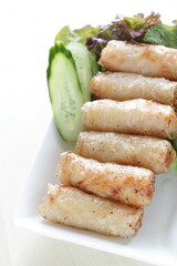 Vietnamese food, deep fried spring roll served with cucumber and salad