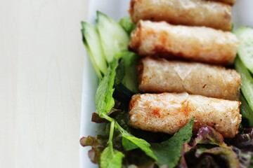 Vietnamese food, deep fried spring roll served with cucumber and salad