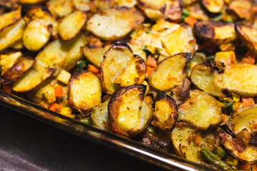 plant-based food, vegan potato bake with garden vegetables and nutritional yeast sauce