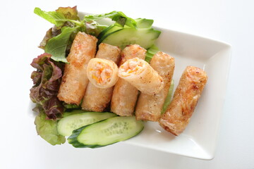 Vietnamese food, deep fried spring roll served with cucumber and salad