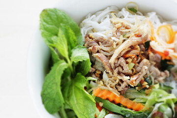 Vietnamese food, grilled pork and rice noodle herbal salad