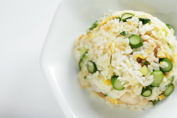 green asparagus and chicken fried rice on white dish