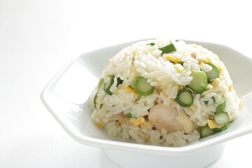 green asparagus and chicken fried rice on white dish
