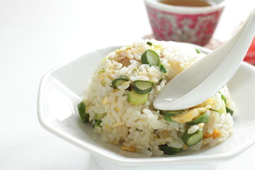 green asparagus and chicken fried rice on white dish
