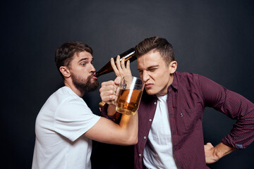 Two drunk friends drinking beer rest fun dark background