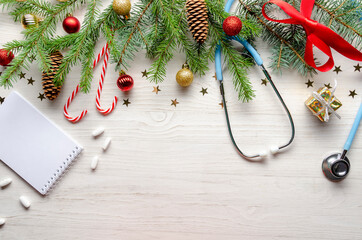 Celebrating Christmas in the health industry. flat lay. Stethoscope with christmas decoration on white background.